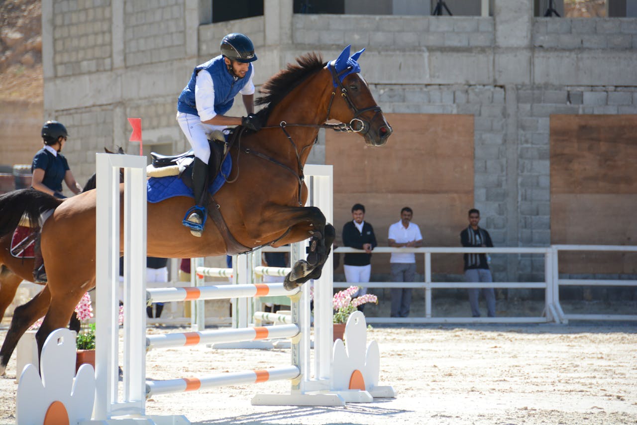 Intense equestrian jumping event showcasing skill and agility in Riyadh.